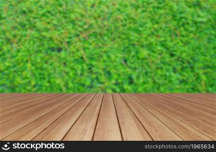Empty table board with vertical garden lush green grass wall pattern surface texture. Close-up of exterior natural material for design. Bushes trees plants growing.