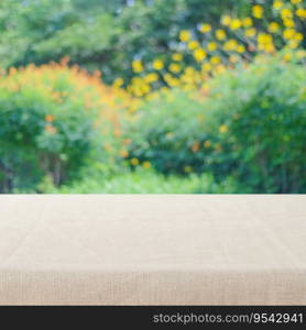 Empty table with linen tablecloth over blur park with bokeh background, food and product display montage