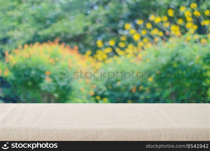 Empty table with linen tablecloth over blur park with bokeh background, food and product display montage