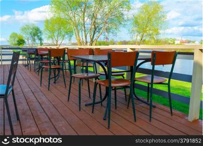 Empty tables in a cafe by the river