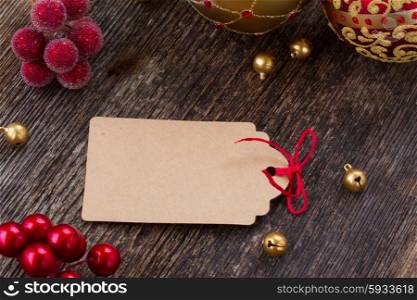 empty tag with red bow in frame of christmas decorations. christmas tag