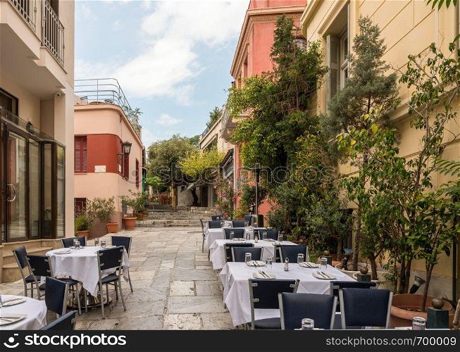 Empty Taverna on steps in ancient neighborhood of Plaka in Athens by the Acropolis. Taverna in ancient residential district of Plaka in Athens Greece