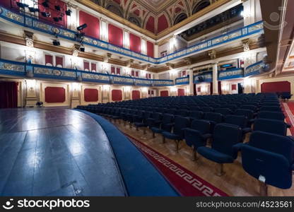 empty theater stage curtain with dramatic lights