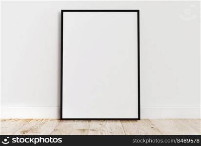 Empty thin black frame on light wooden floor with white wall behind it. Empty poster frame mockup. Empty picture frame mockup. Blank photo frame.
