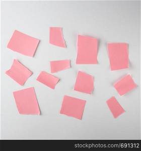 empty torn pieces of pink paper on a white background, top view