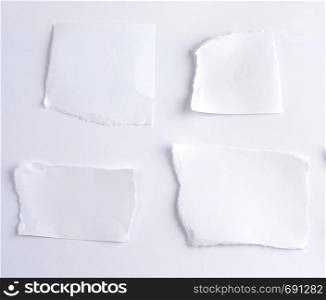 empty torn pieces of white paper on a white background, top view