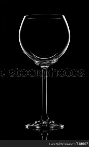 Empty transperent wineglass on a black background