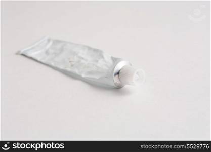 Empty tube of glue on white