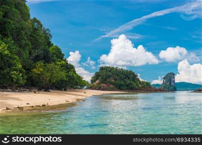 empty uninhabited island with a beach and a beautiful view of the mountains in Thailand