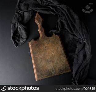 empty vintage wooden brown board and black gauze napkin, top view