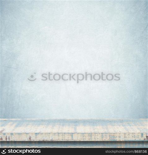 Empty vintage wooden table over blue cement wall background, template, product display montage