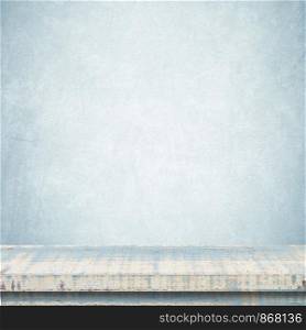 Empty vintage wooden table over blue cement wall background, template, product display montage