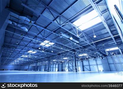 Empty warehouse toned in the blue color