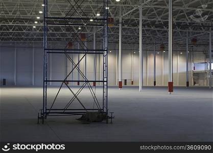 Empty warehouse with scaffold