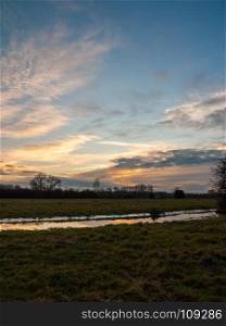 empty wet grass field low light sunset landscape dedham plain empty no people dramatic sky; essex; england; uk