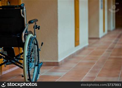 empty wheelchair in the hallway for the disabled