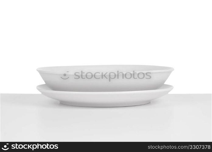 Empty white ceramic soup dish on white background.