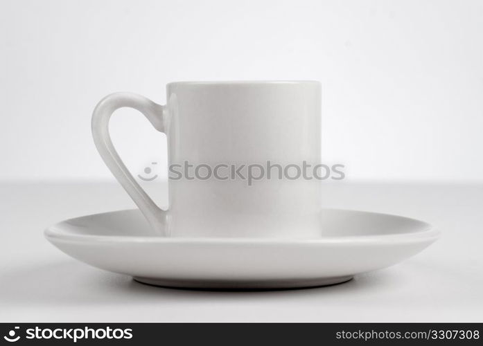 Empty white cup on white background.