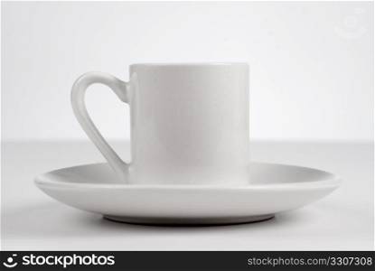 Empty white cup on white background.