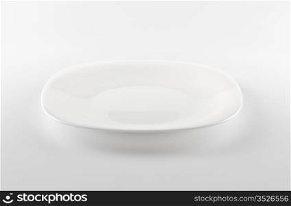 empty white dish on grey background