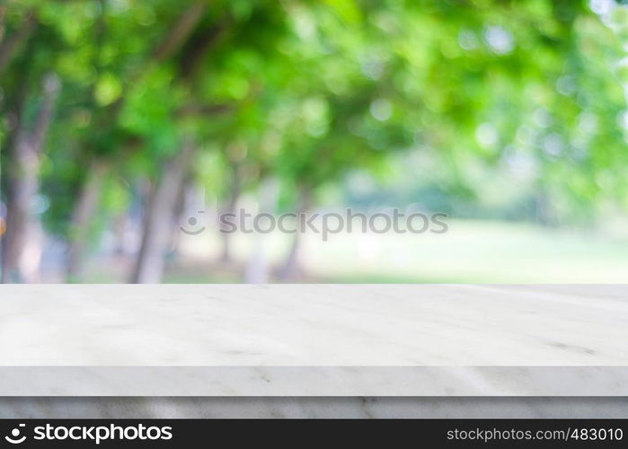 Empty white marble table over blur green nature park background, product display montage