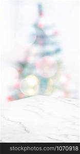 Empty white marble table top with abstract Christmas tree decor string light blur background,Holiday backdrop,Mockup vertical banner for display of product and advertise on online media.ratio16:9