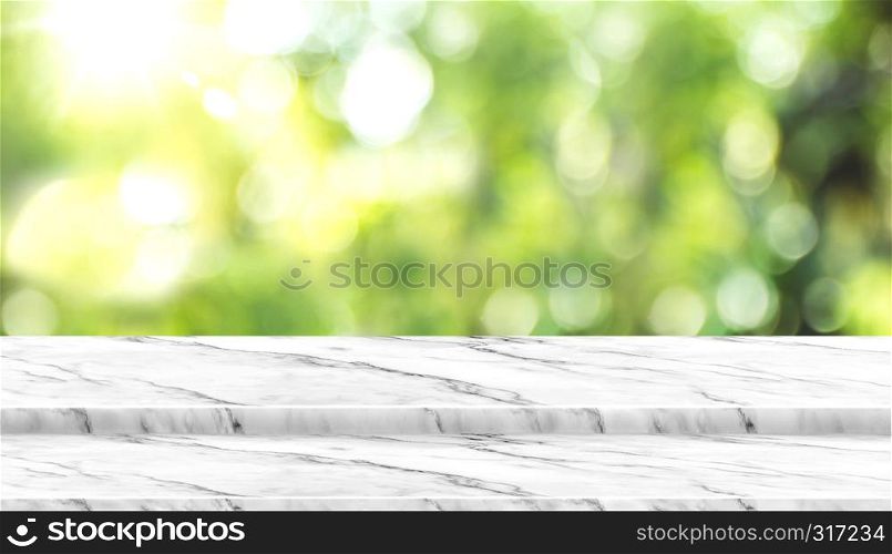 Empty white marble table top with blur tree in park with bokeh light at background,Mock up template for display of your design,Banner for advertise of product,panorama view.