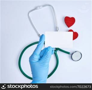 empty white paper card in doctor’s hand, white background with stethoscope