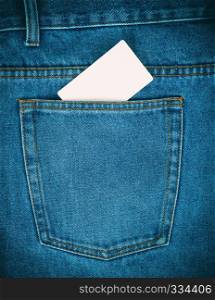 empty white paper card is in the back pocket of blue jeans, full frame