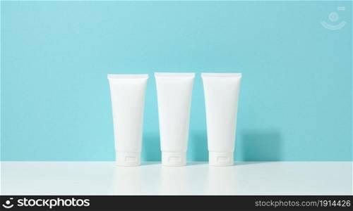 empty white plastic tubes for cosmetics. Packaging for cream, gel, serum, advertising and product promotion, mock up