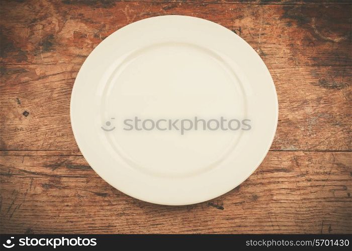 Empty white plate on wood table