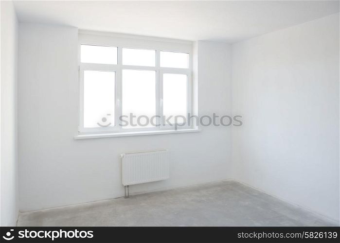 Empty white room with window full of light