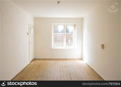empty white room with wooden parquet floor before renovation old empty. empty white room with wooden parquet floor before renovation