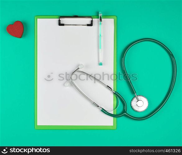 empty white sheets and a medical stethoscope on a green background, place for writing the patient's prescription