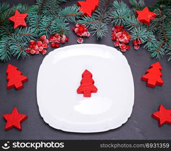 empty white square plate on a black background, top view