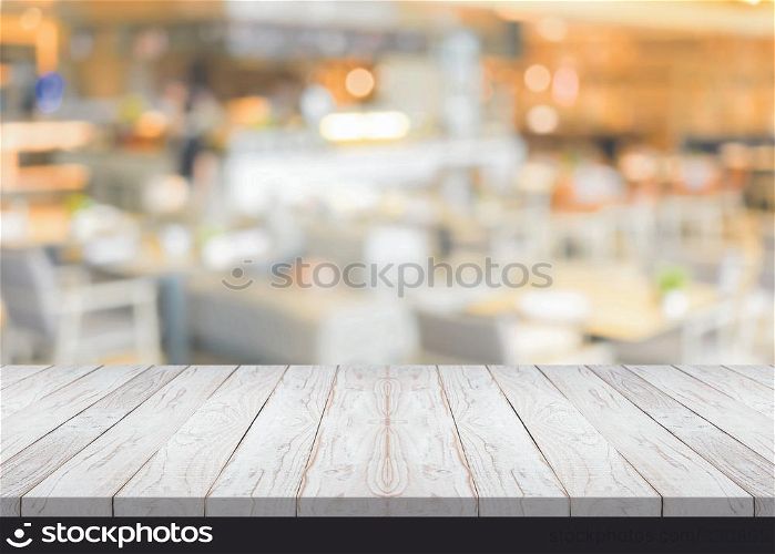 Empty white wood table top on blurred background at coffee shop,copyspace for montage your product