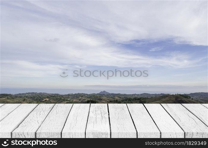 Empty white wood table top over nature blue sky landscape.