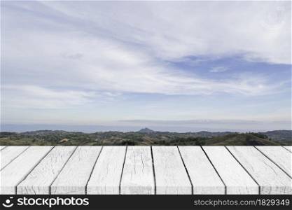 Empty white wood table top over nature blue sky landscape.
