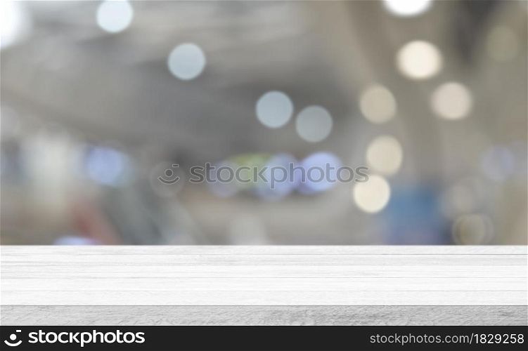 Empty white wood tabletop, desk over blur soft light in restaurant bokeh background, Wood table for product display banner, mock up, Template. Business presentation.