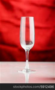 Empty wine glass against the red background