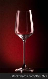 empty wineglass on red background