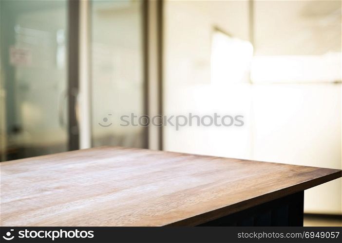 empty wood desk over blurred montage coffee shop cafe / restaurant background