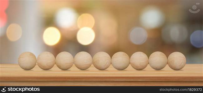 Empty wood sphere on wooden table over blur bokeh background for your creative.