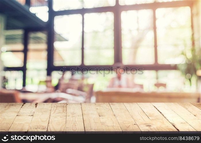 Empty wood table and Blurred background : Customer at coffee shop blur background with bokeh, Vintage toned.
