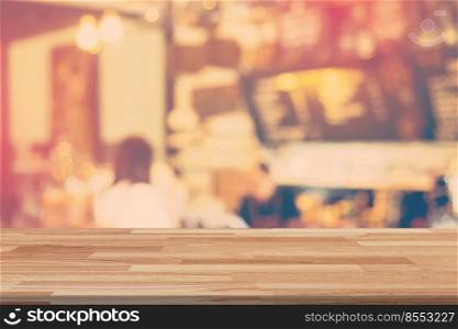 Empty wood table and Blurred background display at coffee shop with space for product.