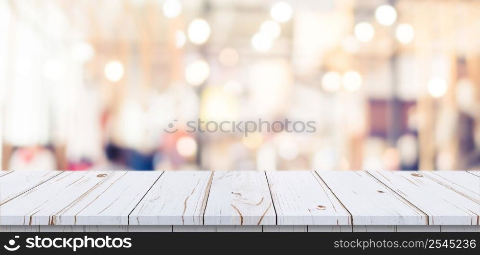 Empty wood table and blurred light table in shopping mall with bokeh background. product display template.