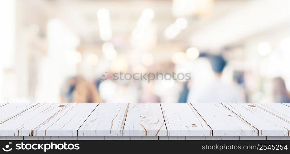 Empty wood table and blurred light table in shopping mall with bokeh background. product display template.