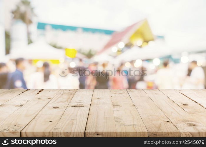 Empty wood table and Vintage tone blurred defocused of crowd people in walking street festival and shopping mall.