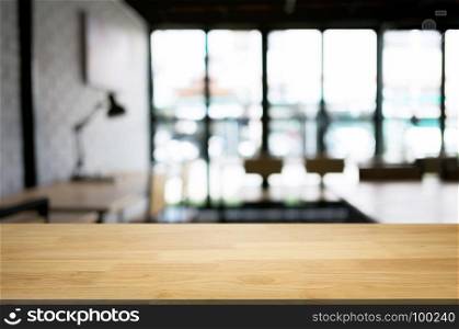empty wood table desk in front of blurred coffee shop cafe background