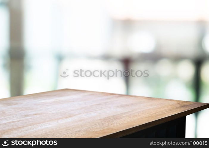 empty wood table in front of blur coffee shop / restaurant background, image can be place product